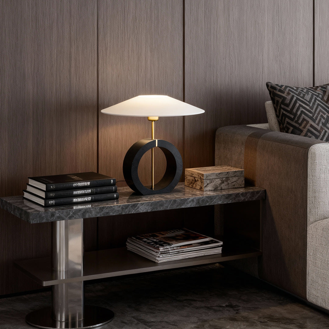 Natural wood table lamp beside sofa in modern living room with warm light.