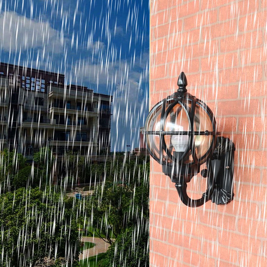 Pair of classic nautical wall lights illuminated during evening rain on building facade