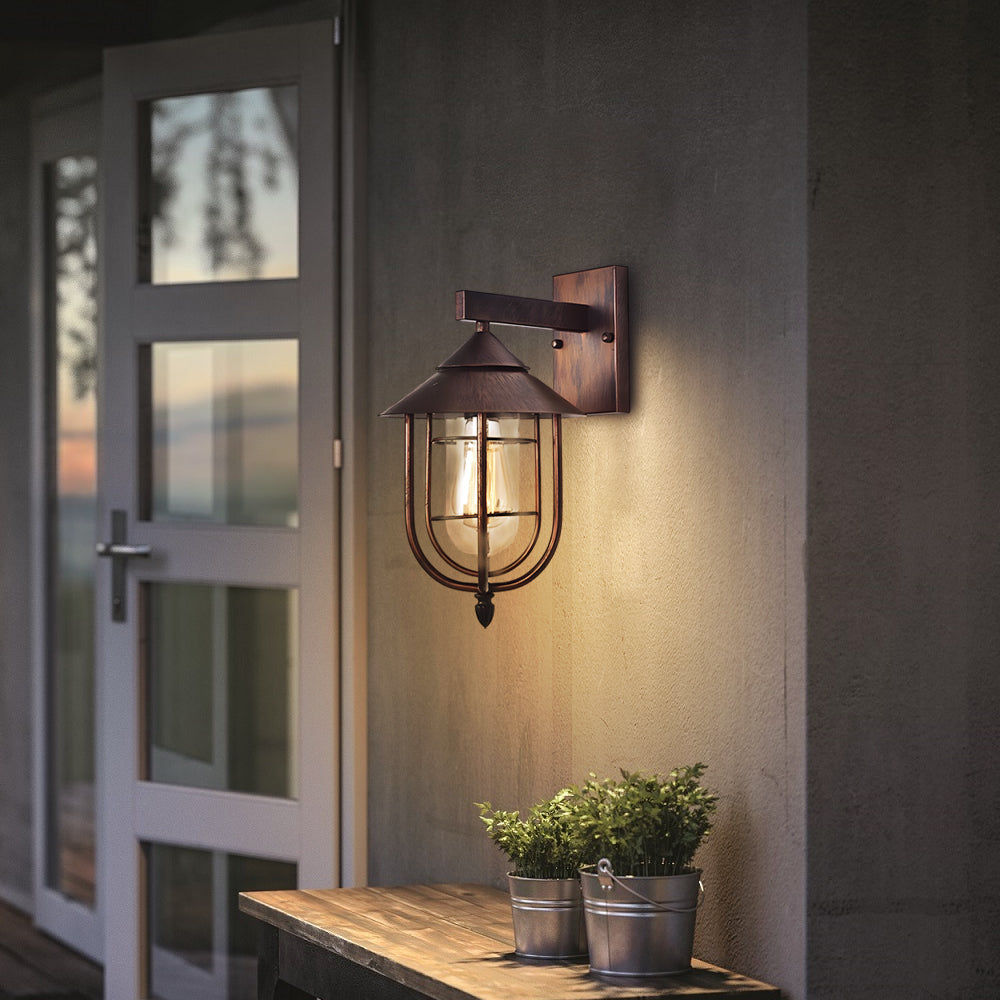 Vintage-style nautical wall sconce by an entry door, providing warm welcoming light for outdoor spaces.