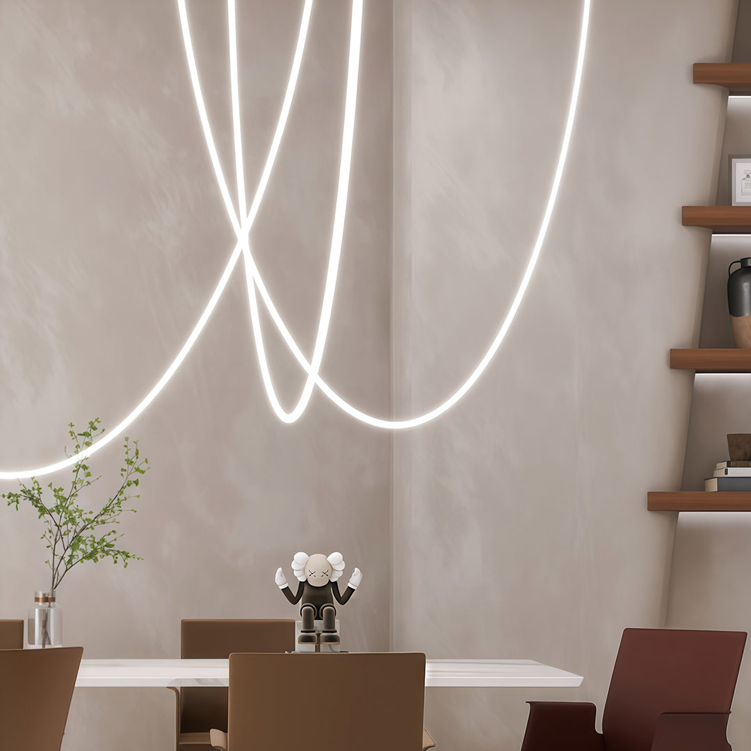 Neon pendant lights arrangement brightening contemporary interior with warm glow and curved forms.