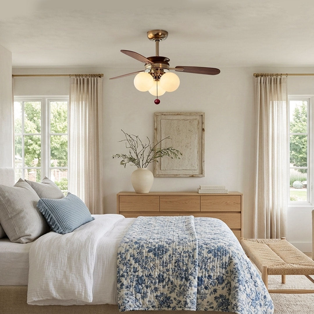Indoor ceiling fan with light installed in a neutral bedroom with dark wood blades and warm illumination.
