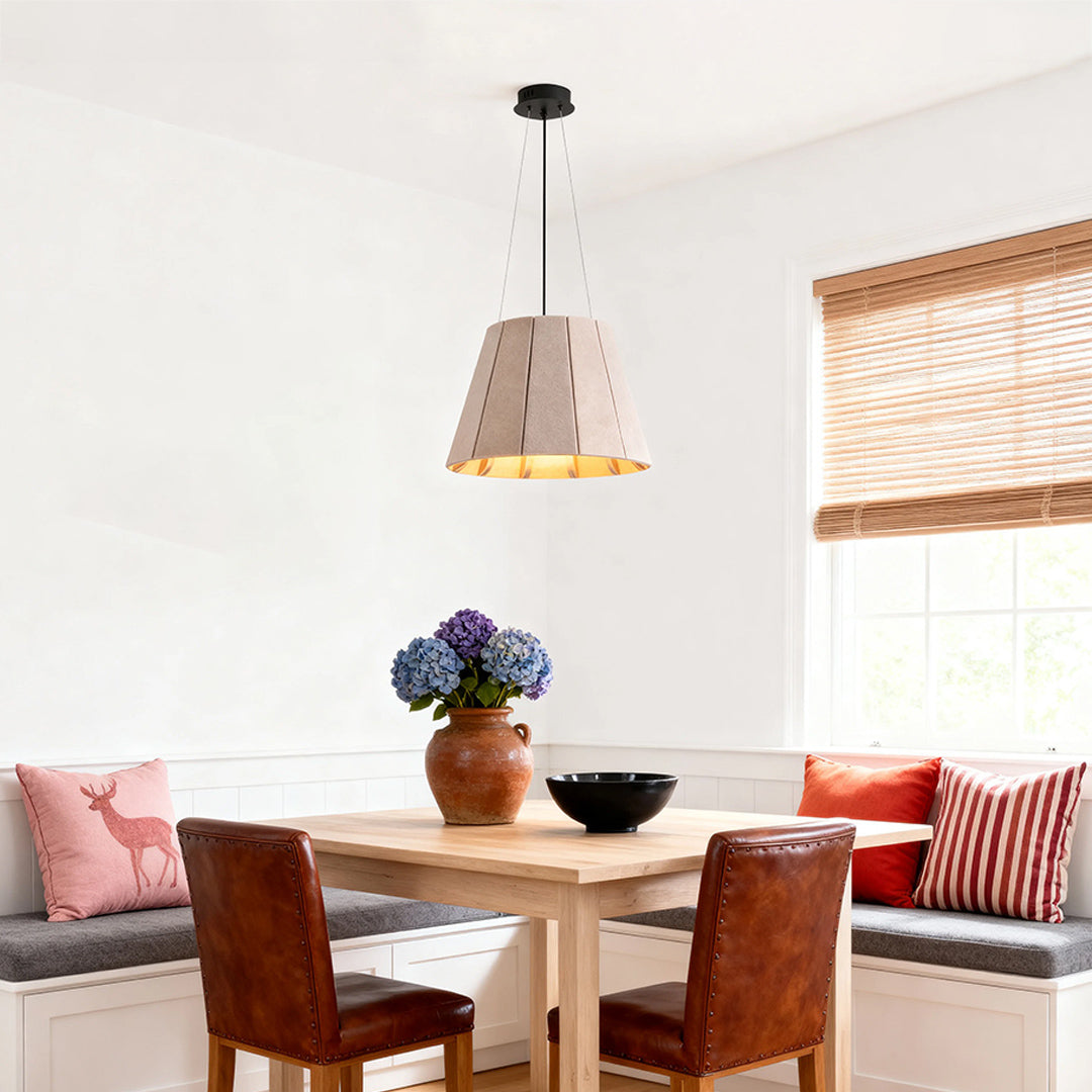 Neutral gray felt industrial pendant light fixture hanging over a built-in bench dining nook with leather chairs. 