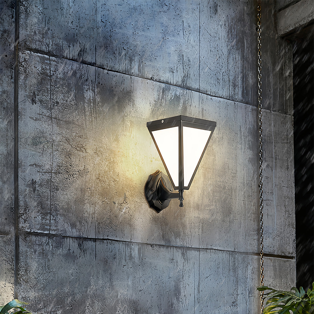 Outdoor solar lights wall mounted on textured concrete wall glowing warmly at night.