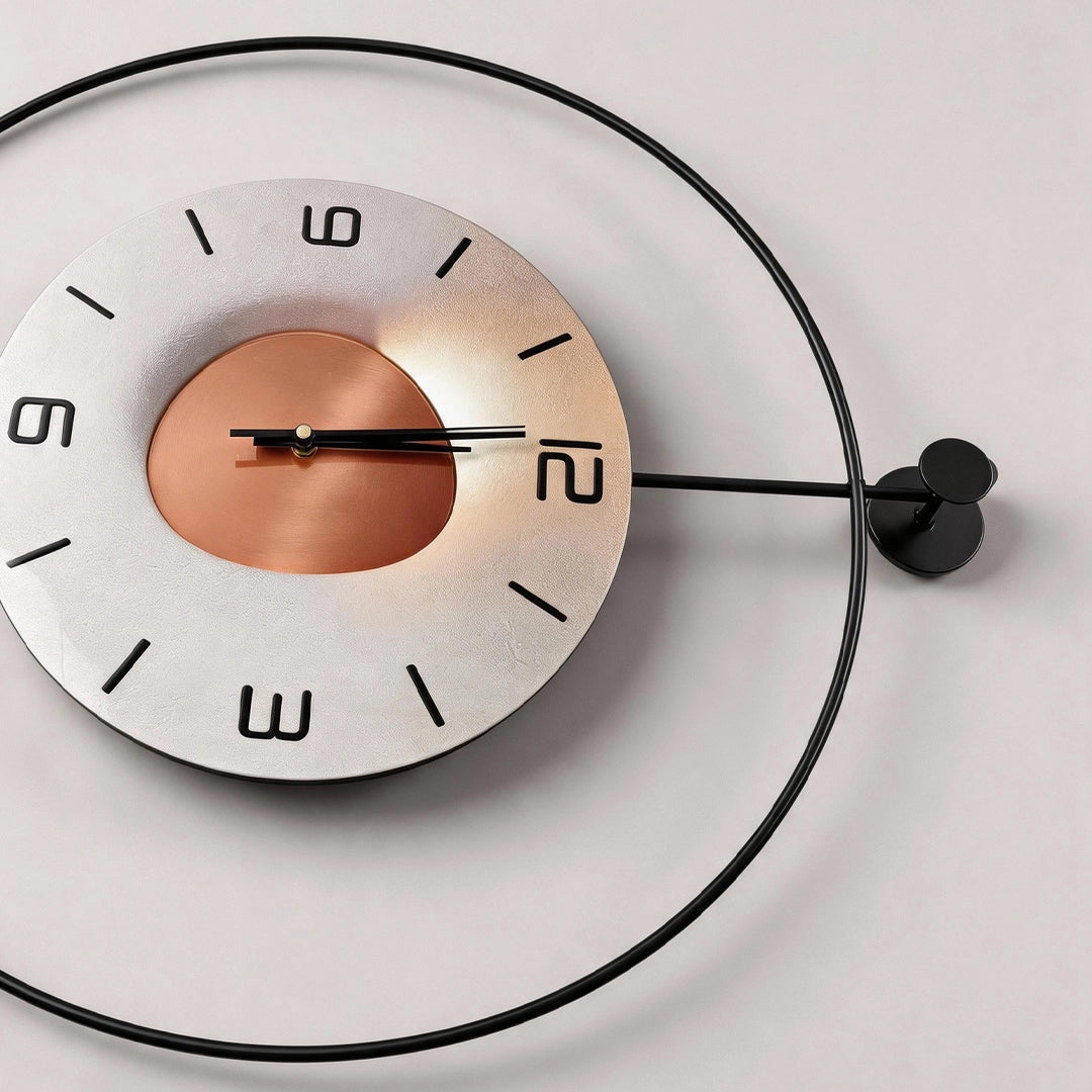 Night light wall clock with a round white dial, copper center, black hands, and circular metal frame.