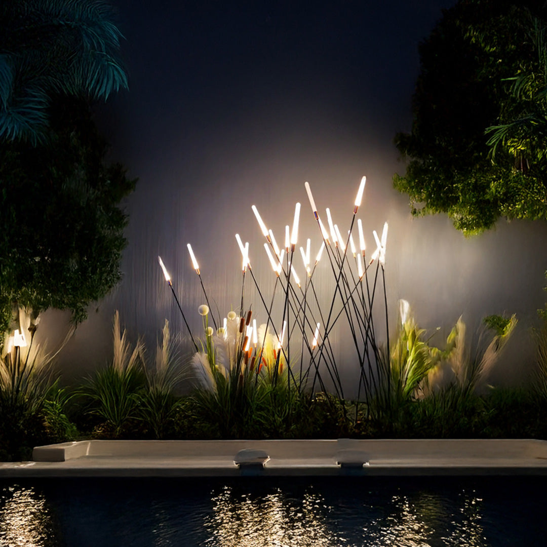 Nighttime landscape spike light display creating dramatic illumination effects in modern residential outdoor space