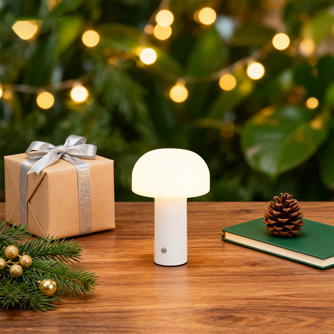 White novelty table lamps adding festive charm to holiday display with greenery and pinecones