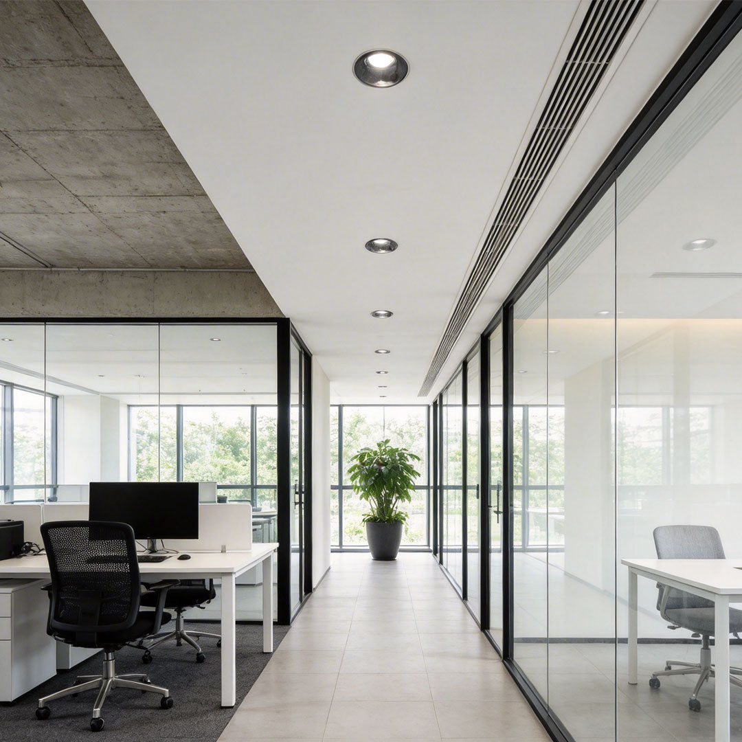 Modern office with LED spotlights illuminating the workspace in a bright, open area.