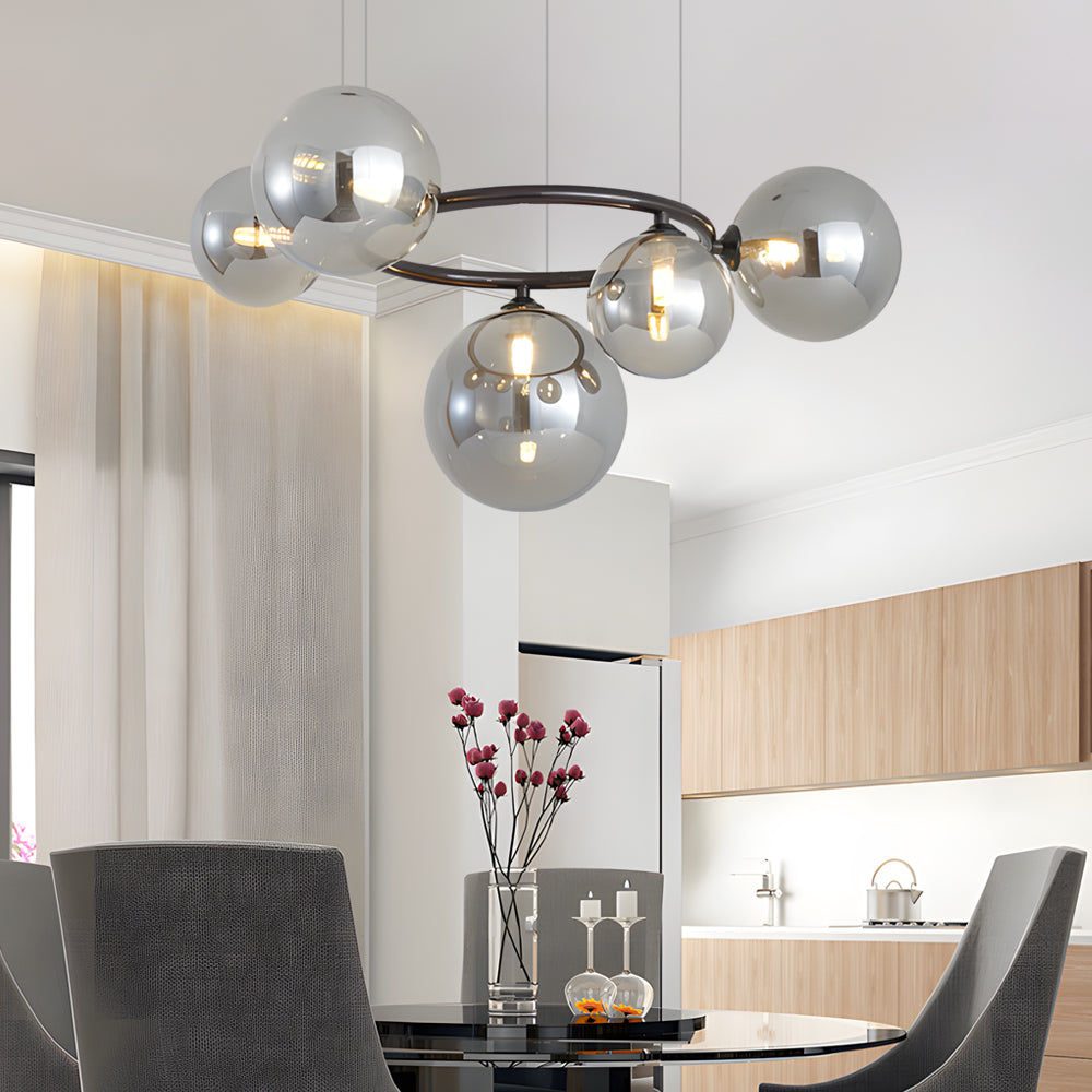 Opal glass globe chandelier with a black frame, illuminating a contemporary bedroom.