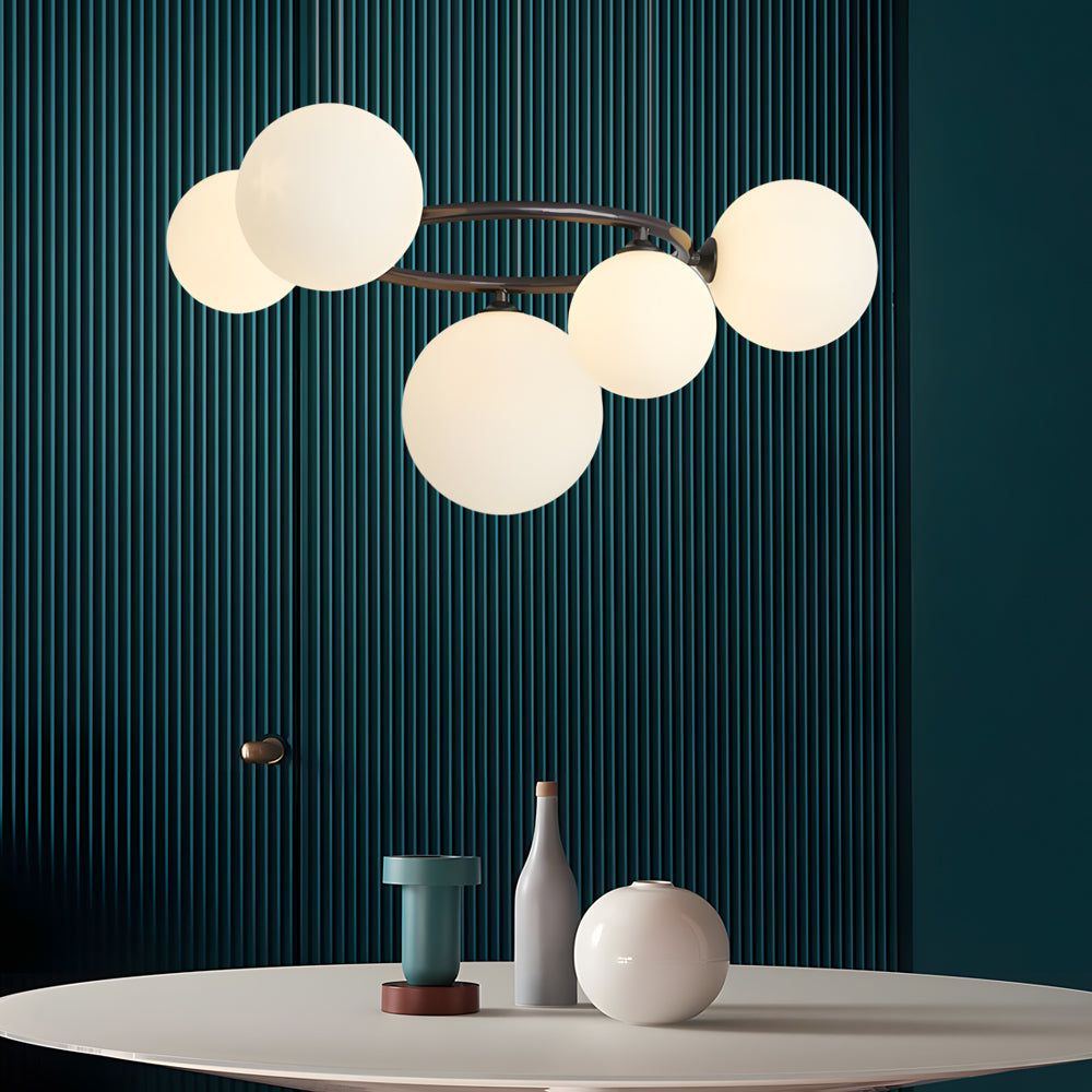 Opal glass globe chandelier with a copper frame, providing ambient lighting in a stylish room.