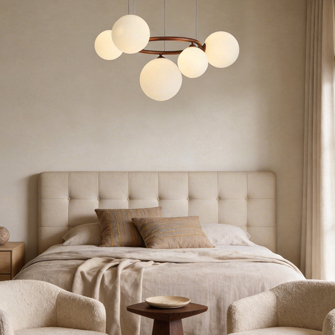 Opal glass globe chandelier with a copper frame, providing elegant lighting in a dining room.