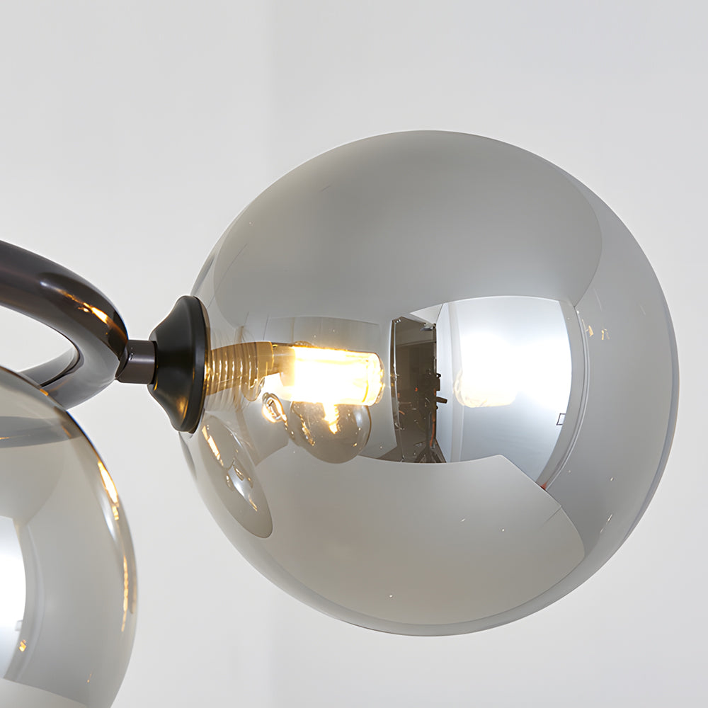 Opal glass globe chandelier with a copper frame, providing elegant lighting in a modern room.