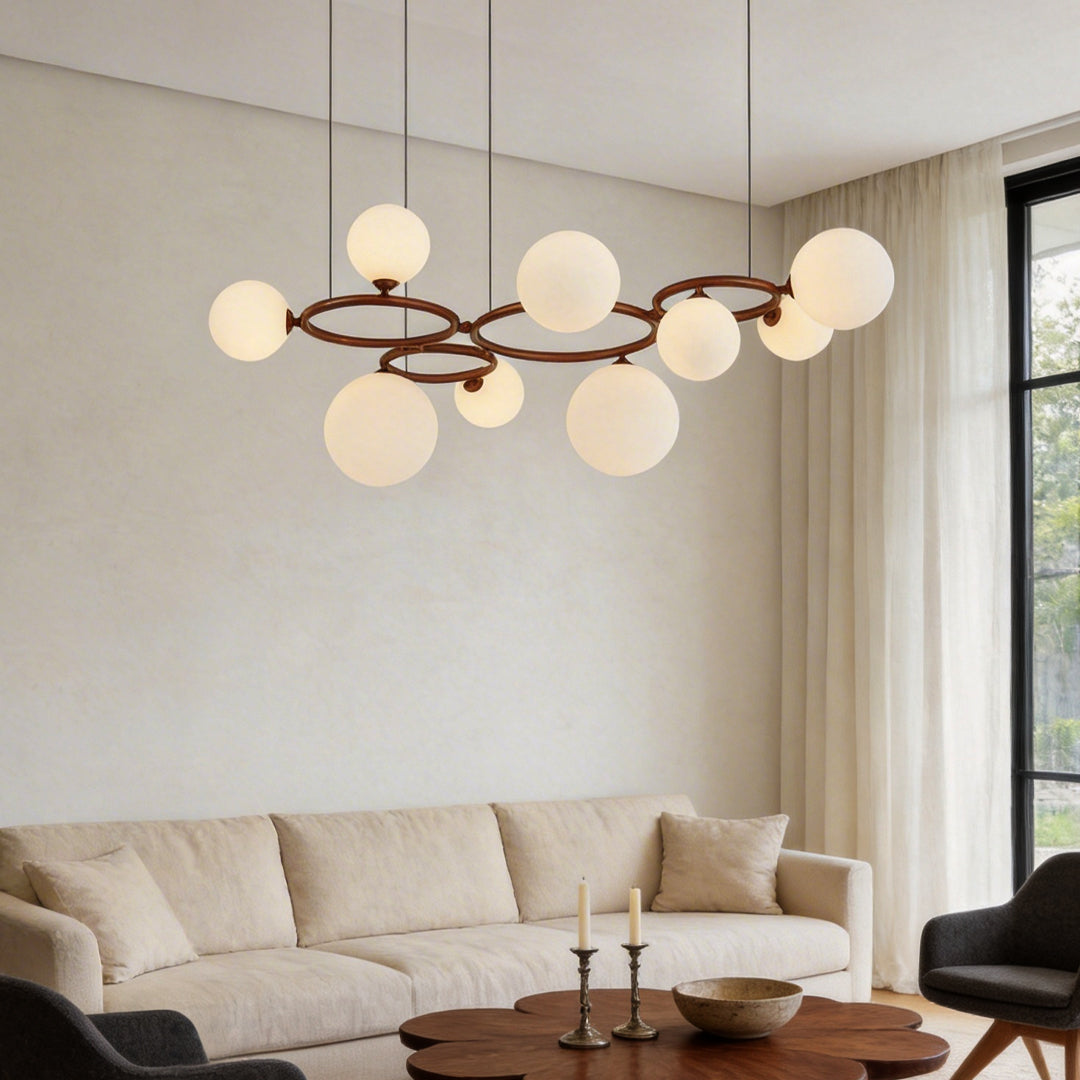 Opal glass globe chandelier with a modern design, hanging above a cozy living room sofa.