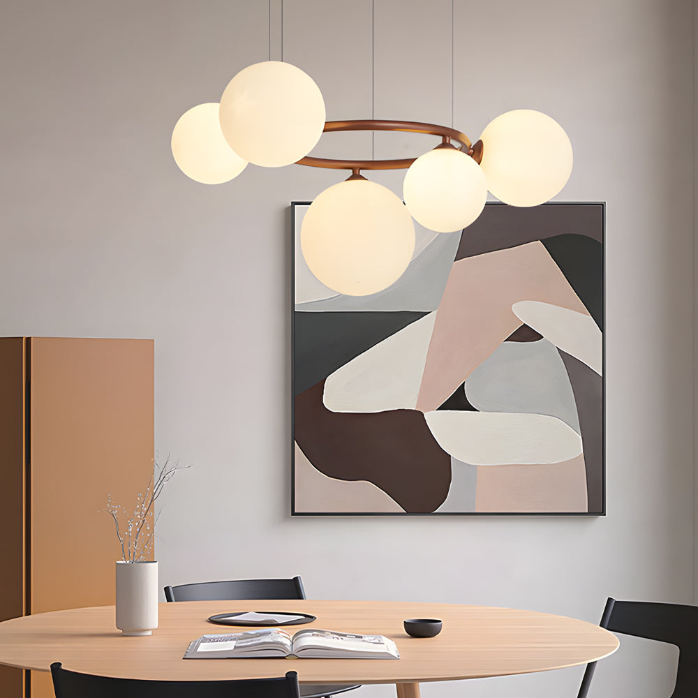 Opal glass globe chandelier with a sleek design, illuminating a contemporary dining table.