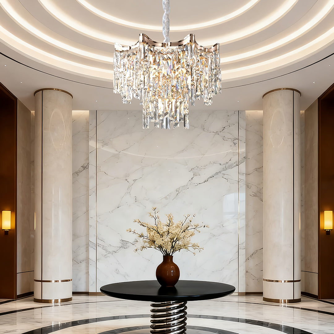Opulent tiered glass chandelier enhancing grand foyer with marble floors and classical architecture