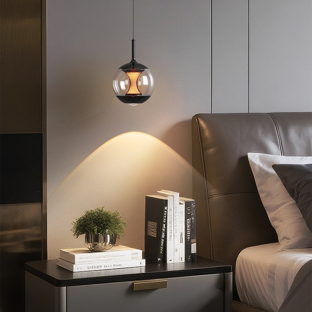 Orb pendant light creating ambient glow above nightstand in modern bedroom with neutral color palette
