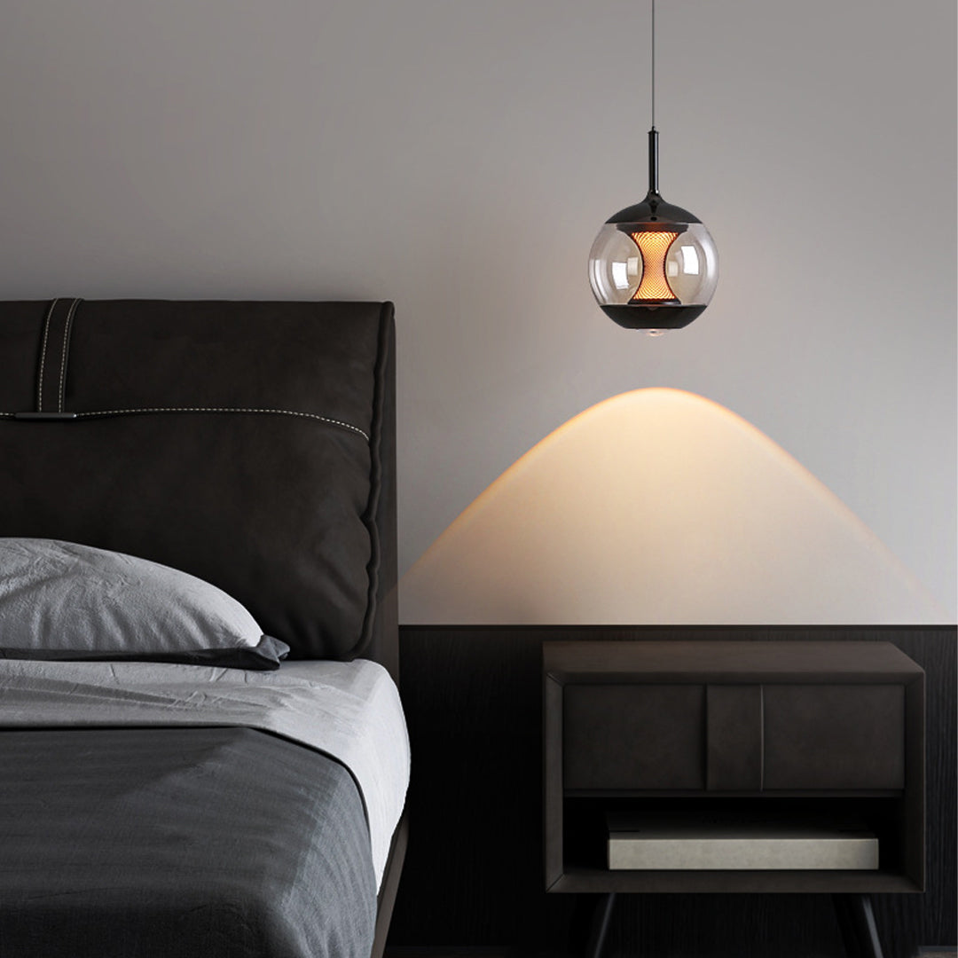 Orb pendant light providing bedside illumination in contemporary bedroom with black platform bed and gray walls
