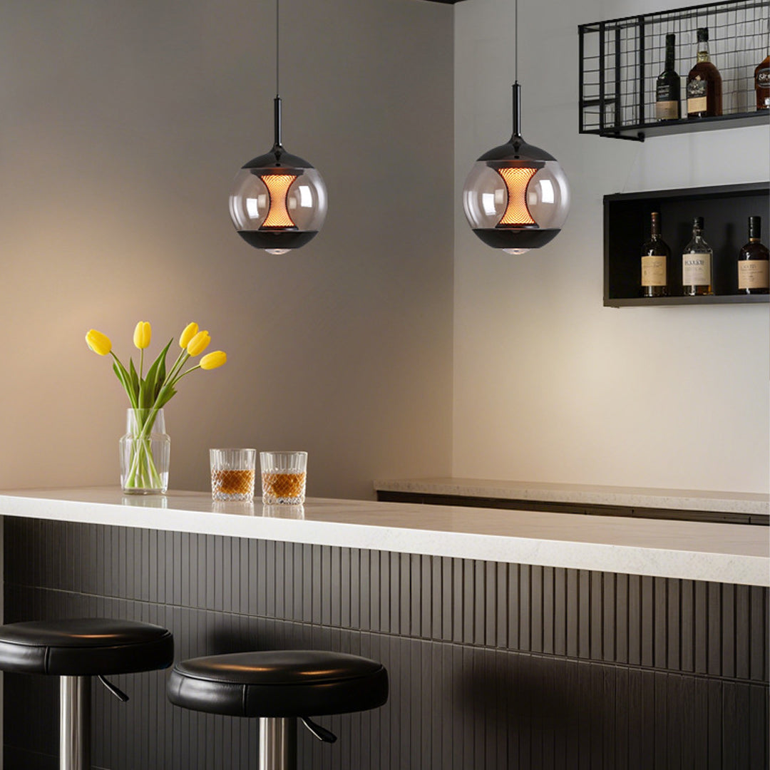 Pair of orb pendant lights hanging above dining table in contemporary kitchen with textured cabinetry