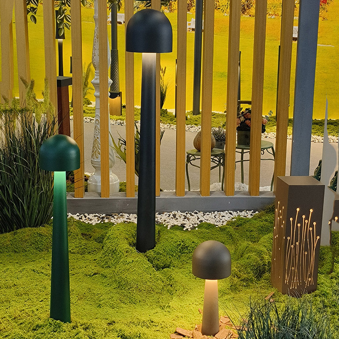 Orb-shaped modern landscape light with a perforated metal design, casting decorative light patterns in outdoor spaces