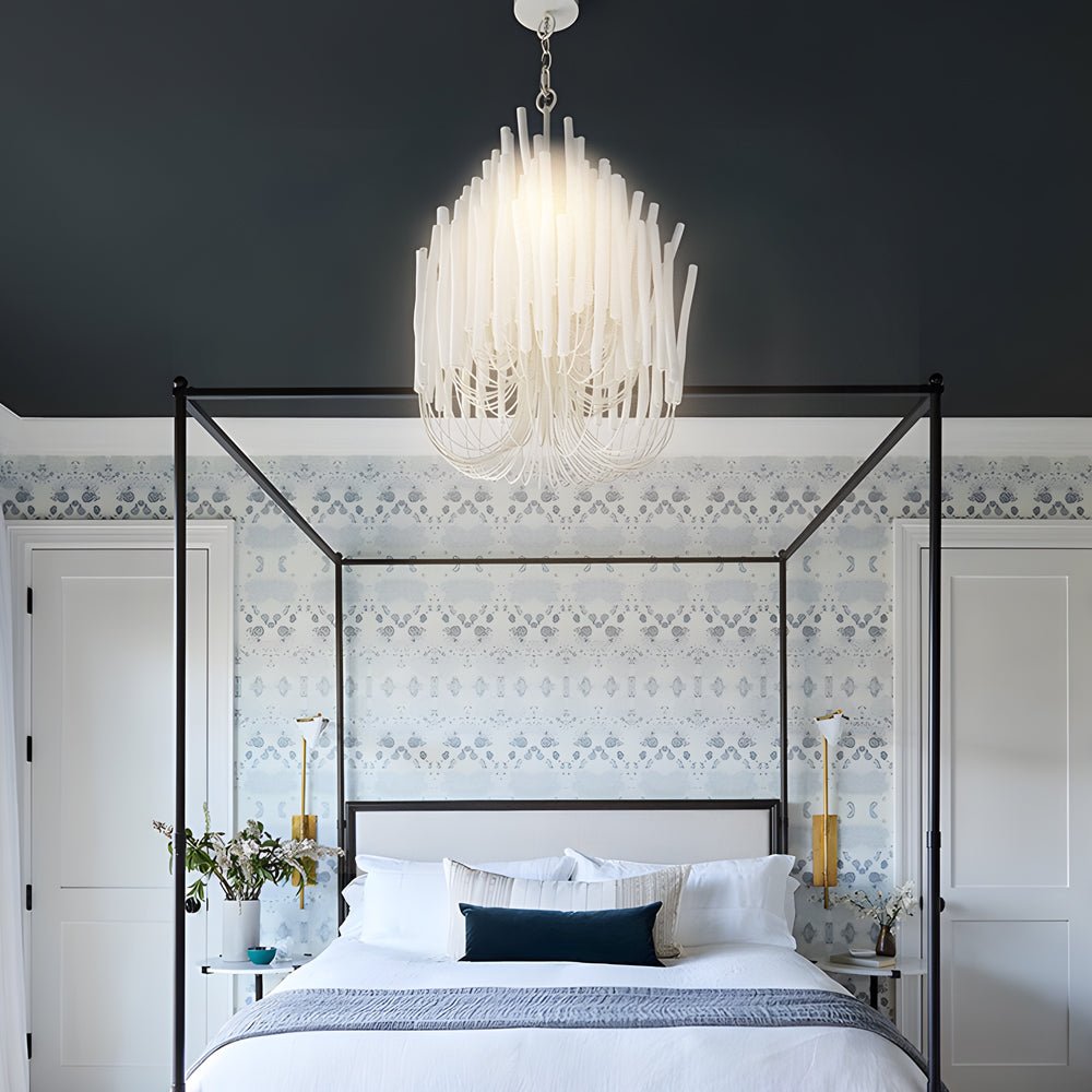Organic stick chandelier in a luxurious bedroom, casting a soft glow over a canopy bed.