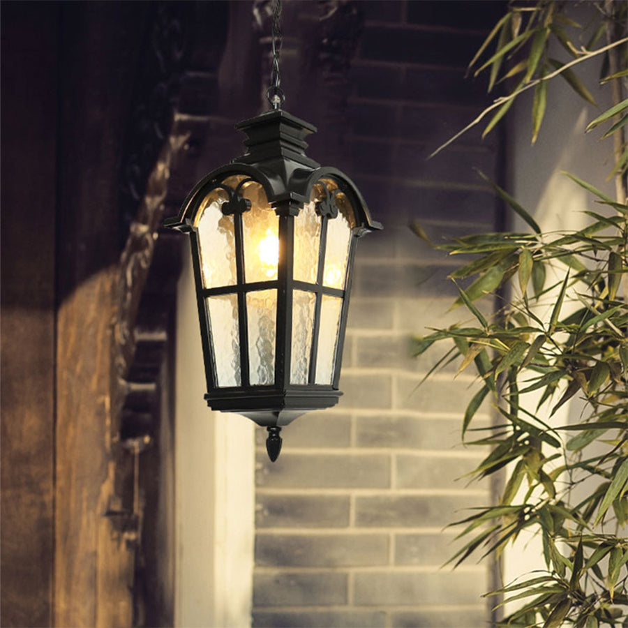 Ornate black hanging lantern with amber glass creating warm evening ambiance