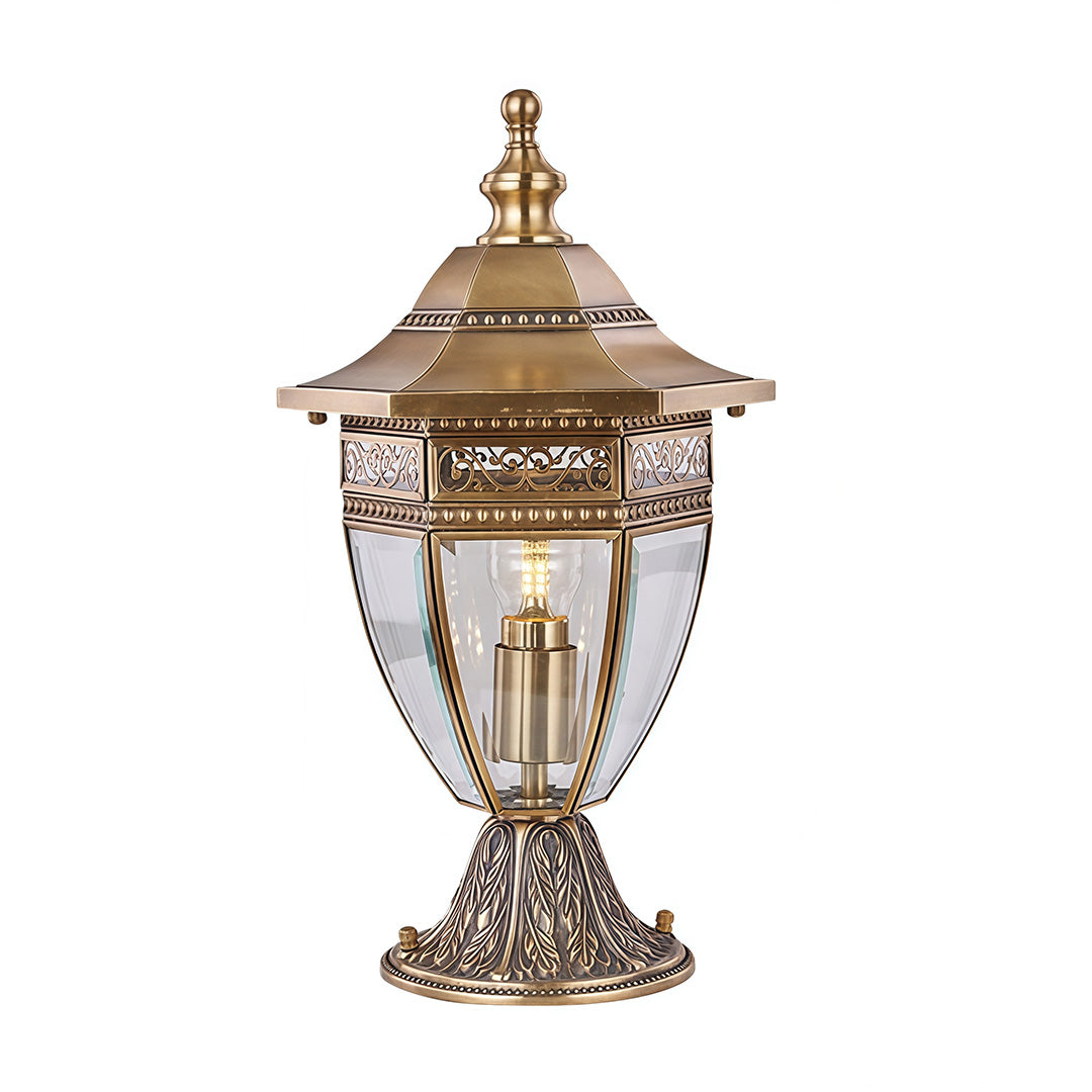 Ornate glass pillar light with gold accents, mounted on a stone pillar, enhancing the entrance of a luxurious home.