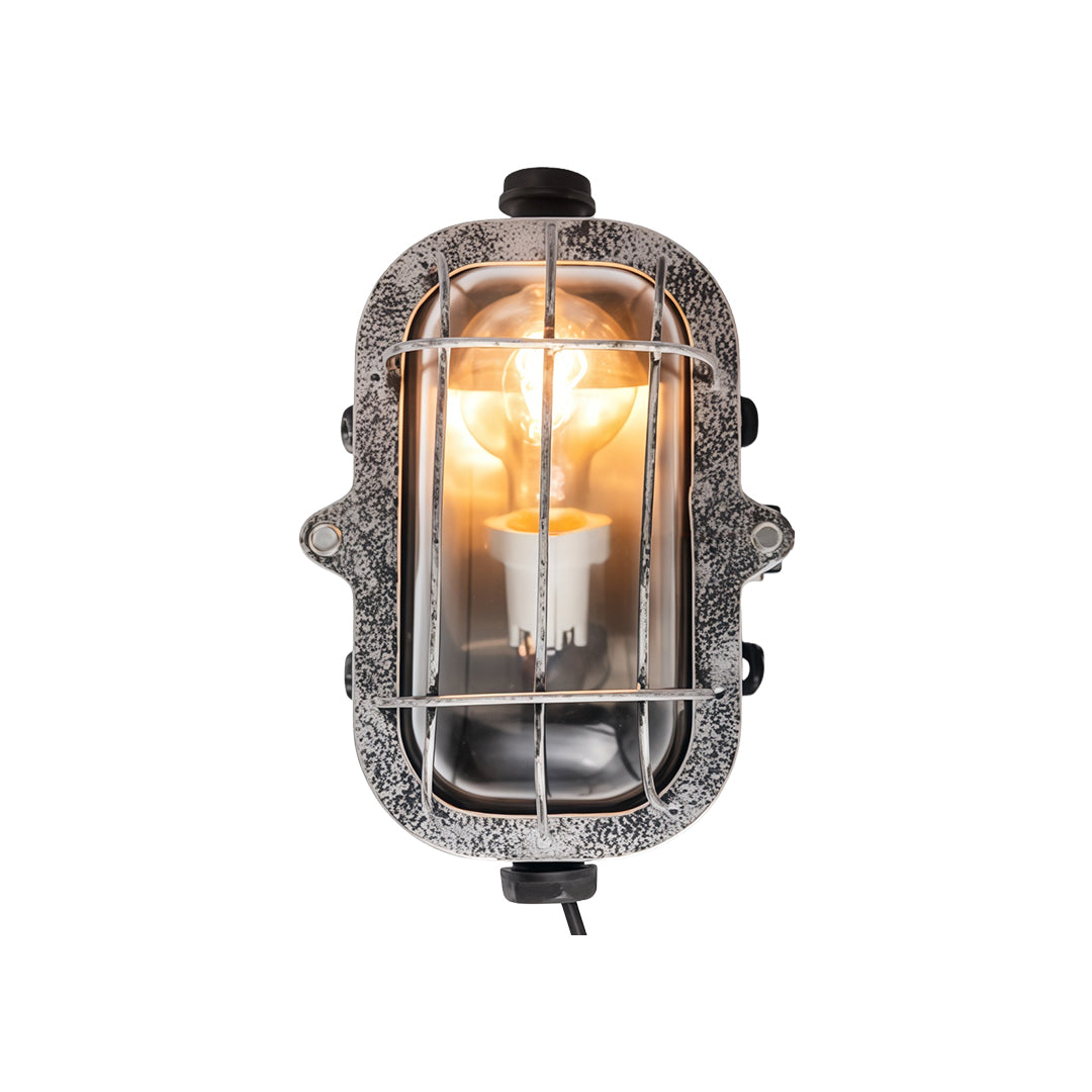 Ornate industrial outdoor sconce featuring caged bulb design with decorative vintage metal hardware accents