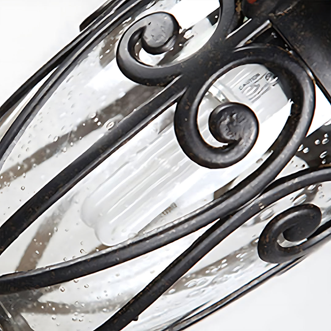 Detailed view of ornate scrollwork pattern on black metal lantern fixture