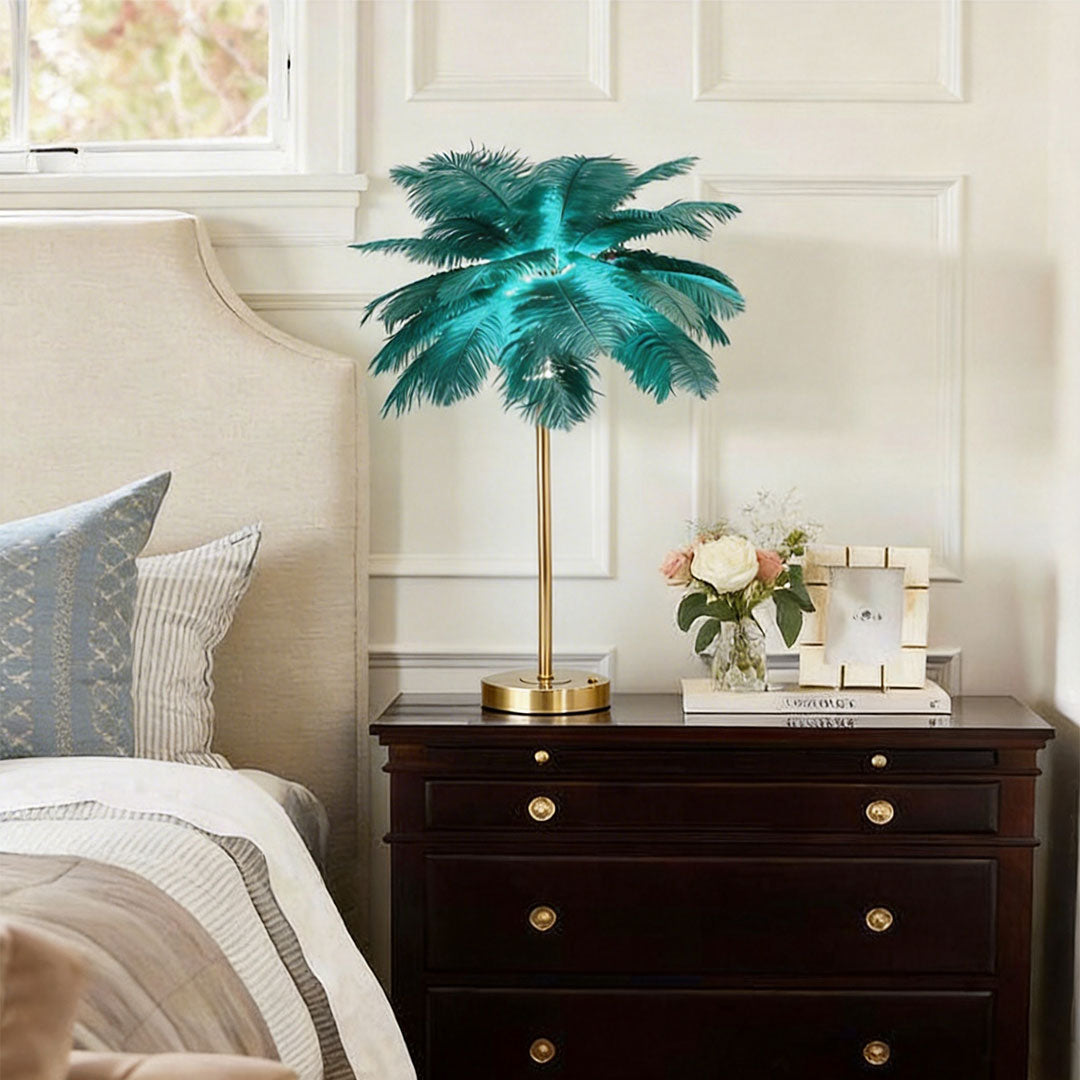 Ostrich feather table lamp with a teal feather design, placed beside a classic bedroom dresser.