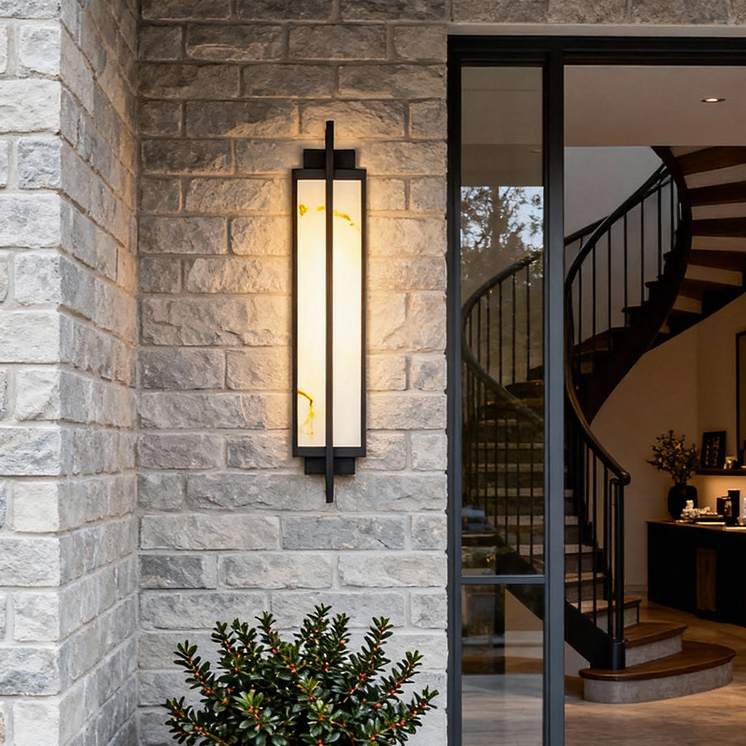 Outdoor alabaster wall sconces installed on brick wall, providing soft ambient illumination.