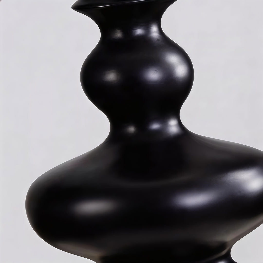 Close-up of outdoor black floor lamps showcasing its spherical light and black base.