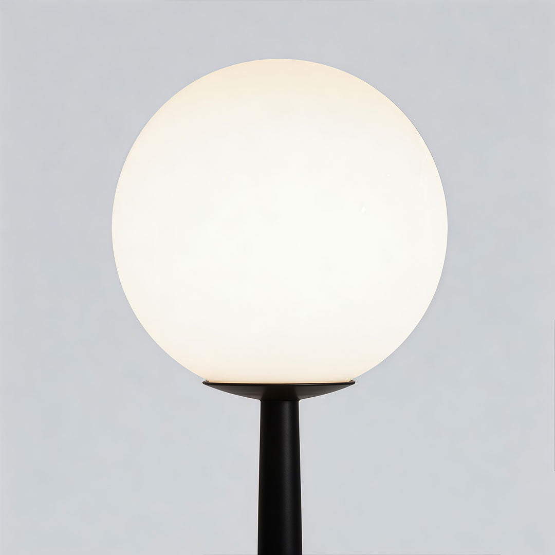 Outdoor black floor lamps with a modern spherical design, providing ambient lighting.