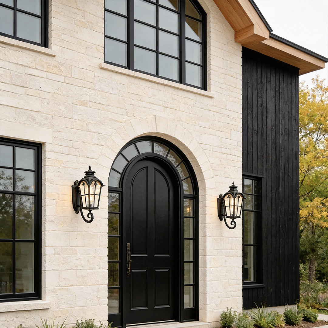 Outdoor black sconce with a classic design, illuminating the exterior of a modern house.
