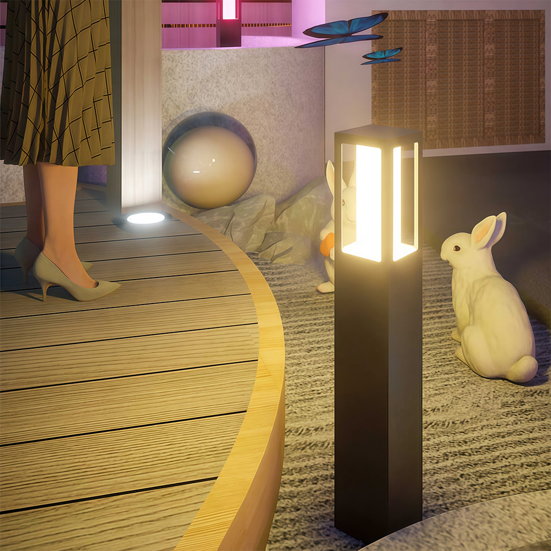 Outdoor bollard light along a garden pathway with stepping stones, offering stylish and functional lighting.