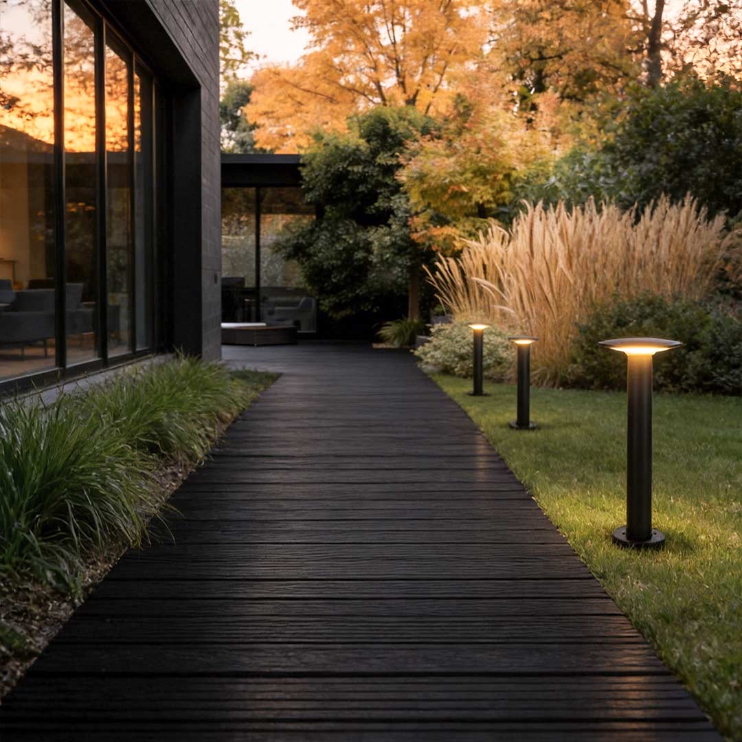Outdoor bollards lighting enhancing a contemporary wooden walkway at dusk.