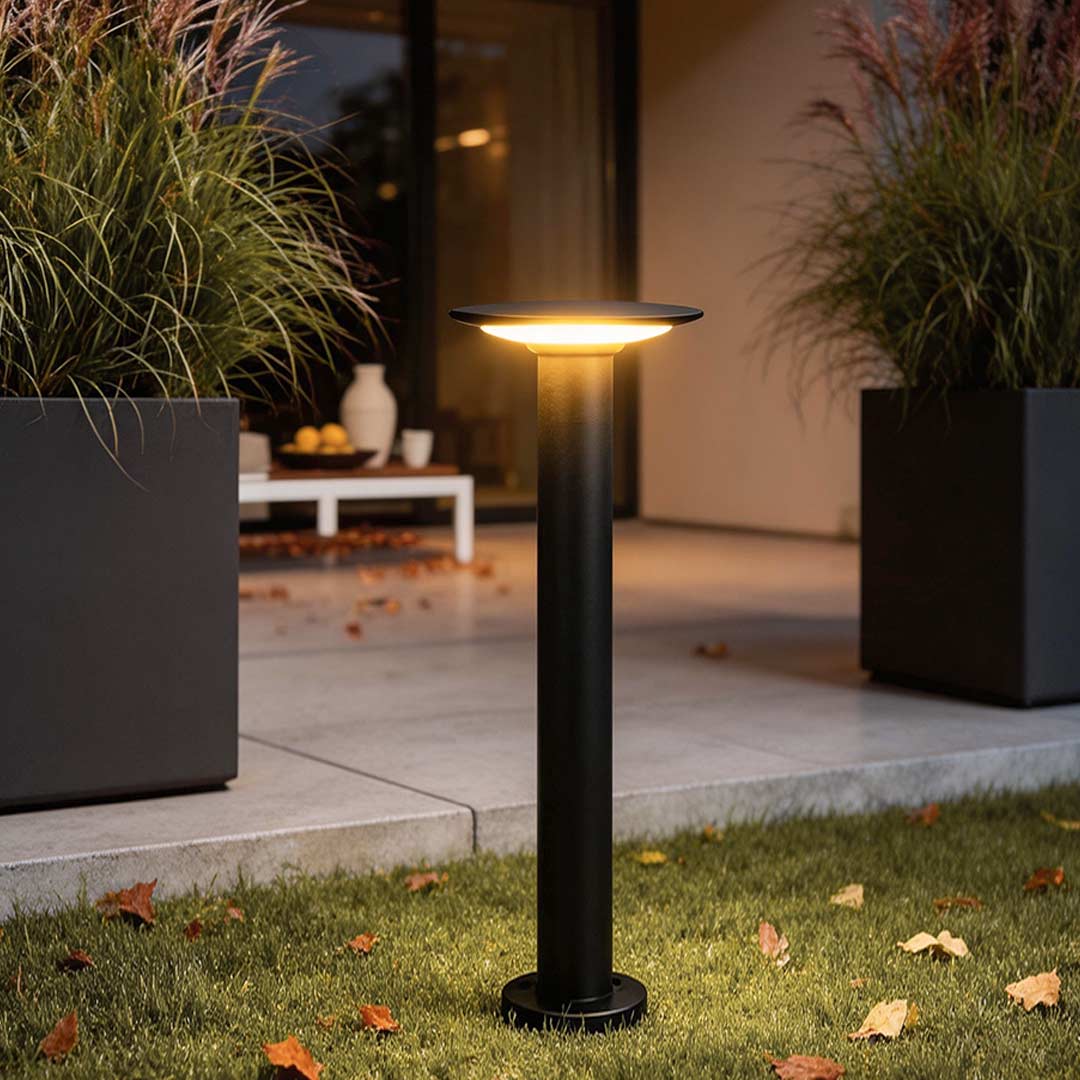 Outdoor bollards lighting illuminating a modern garden pathway with warm directional glow.