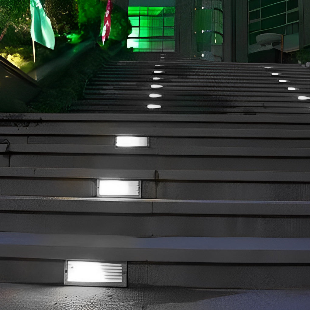 Outdoor brick light installed in wide exterior steps, delivering evenly spaced illumination for safe outdoor stair navigation at night.