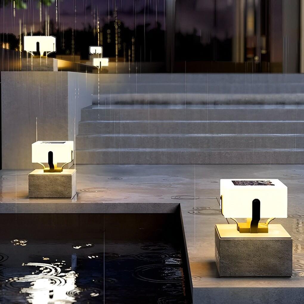 Outdoor brick pillar lights close-up, showcasing the square design and warm illumination.