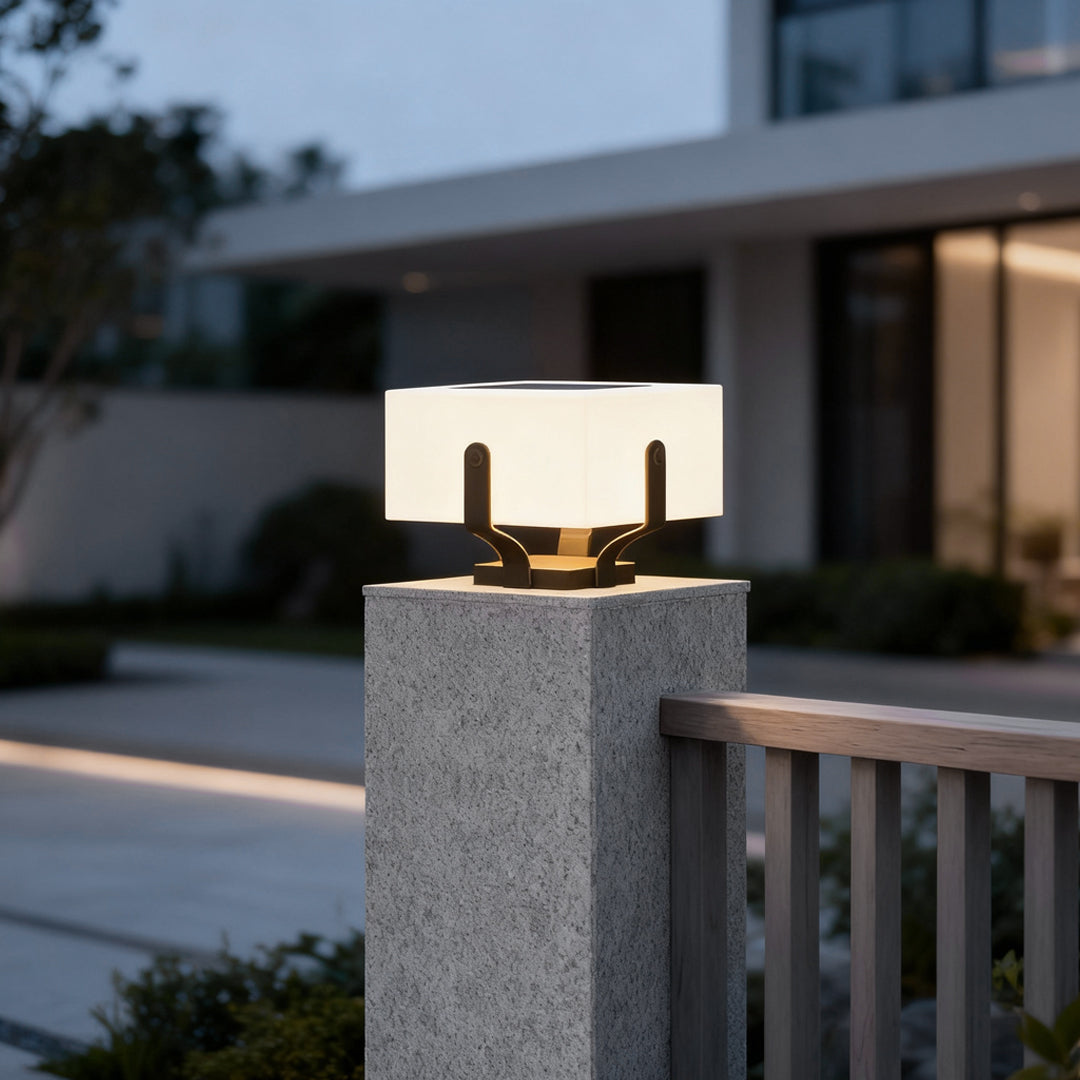 Outdoor brick pillar lights adding a stylish touch to a modern fence and stone pillar setup.