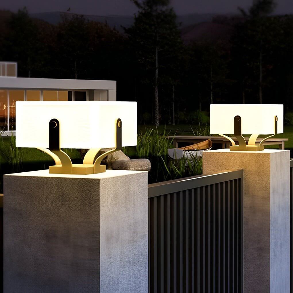 Outdoor brick pillar lights near a water feature, providing a sophisticated glow to the landscape.
