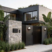 Outdoor ceiling lighting fixtures illuminating a modern house entrance with warm directional glow.