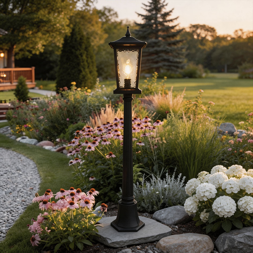 Outdoor driveway pillar lights with a classic design, lighting up a garden pathway.