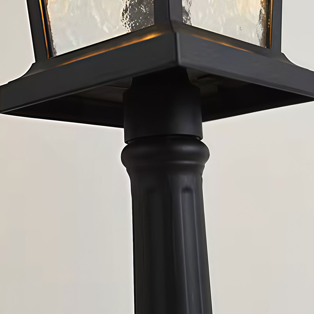 Close-up of outdoor driveway pillar lights showcasing frosted glass panels.
