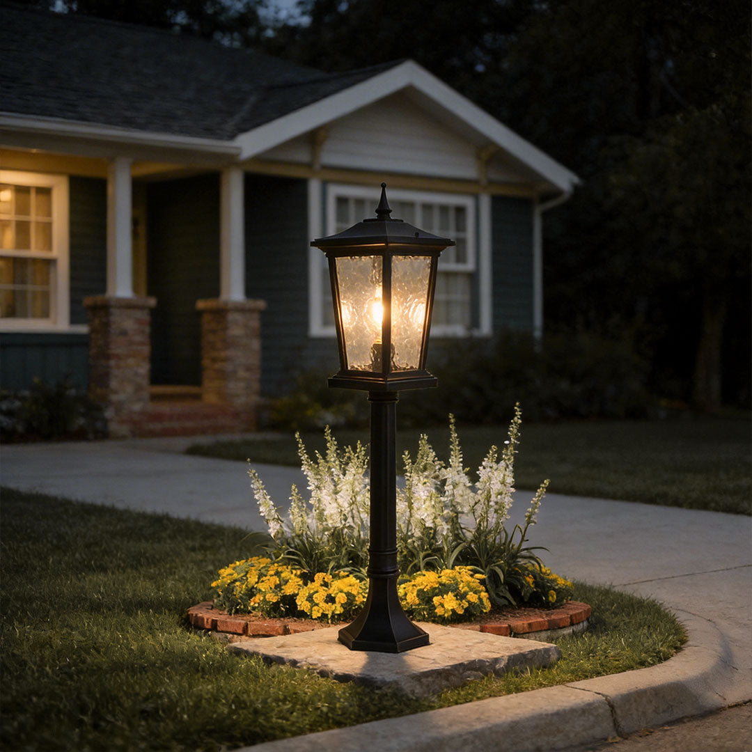 Outdoor driveway pillar lights with a modern design, providing warm illumination near a driveway.