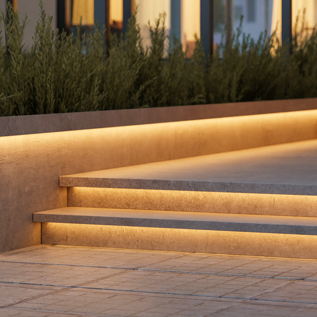 Outdoor embedded LED light strips enhancing garden steps with sleek, directional lighting.