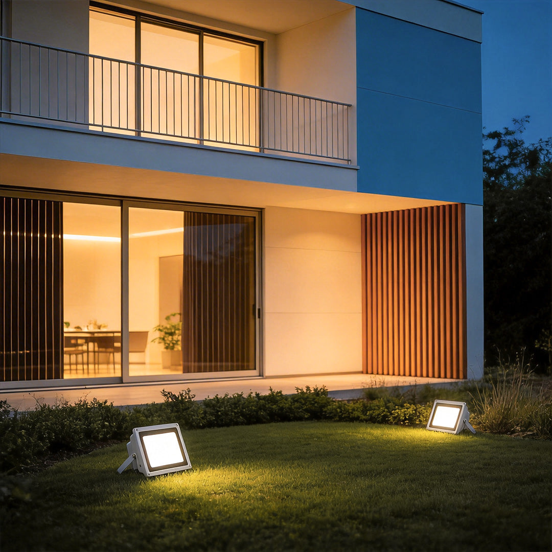 Outdoor flood lights LED providing bright illumination near a modern house entrance.