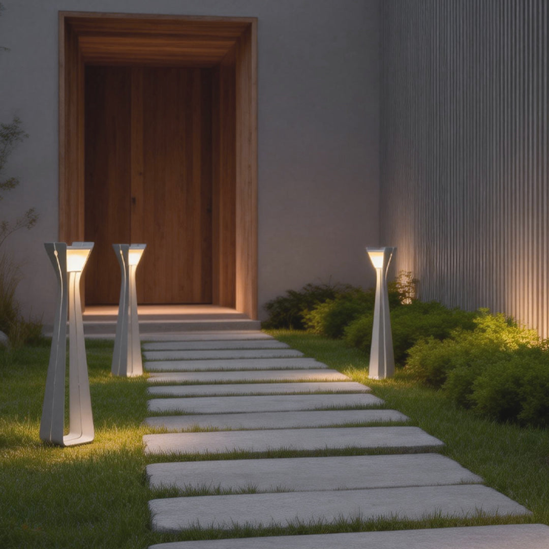 Outdoor floor lamps for porches placed along a garden path entrance, creating a welcoming and softly illuminated approach.