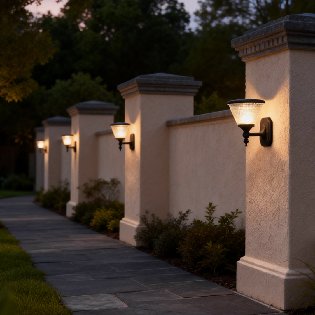 Outdoor funnel wall light series lining a paved walkway, providing warm ambient lighting for the garden area.