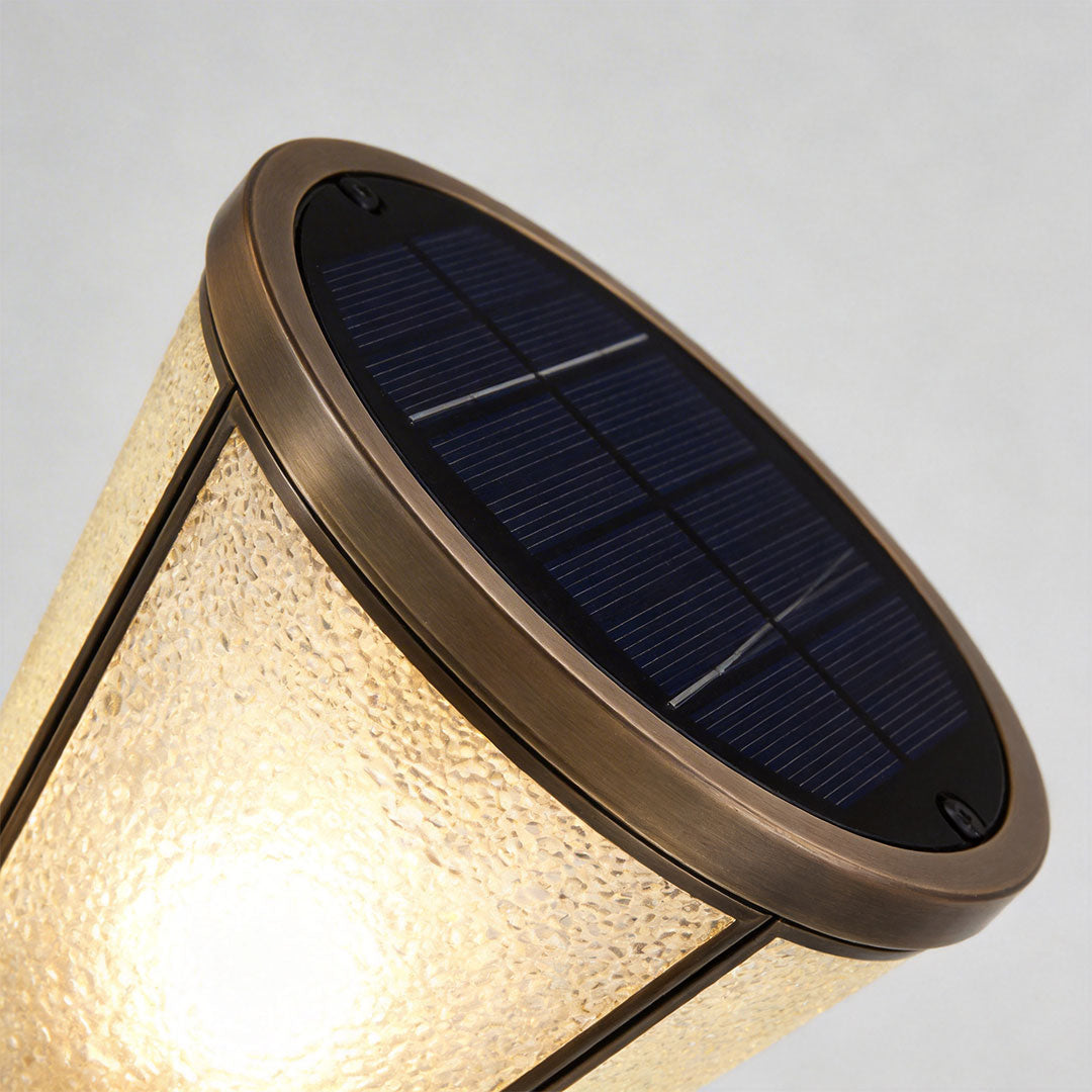 Close-up of outdoor garden path lights showcasing frosted glass and bronze finish.