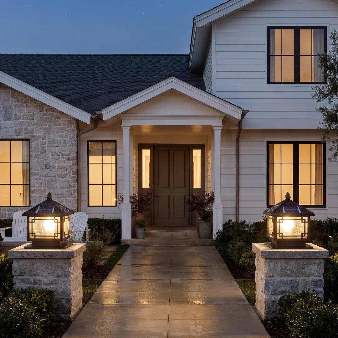 Outdoor garden pillar lights mounted on entry columns beside a modern front path and porch.