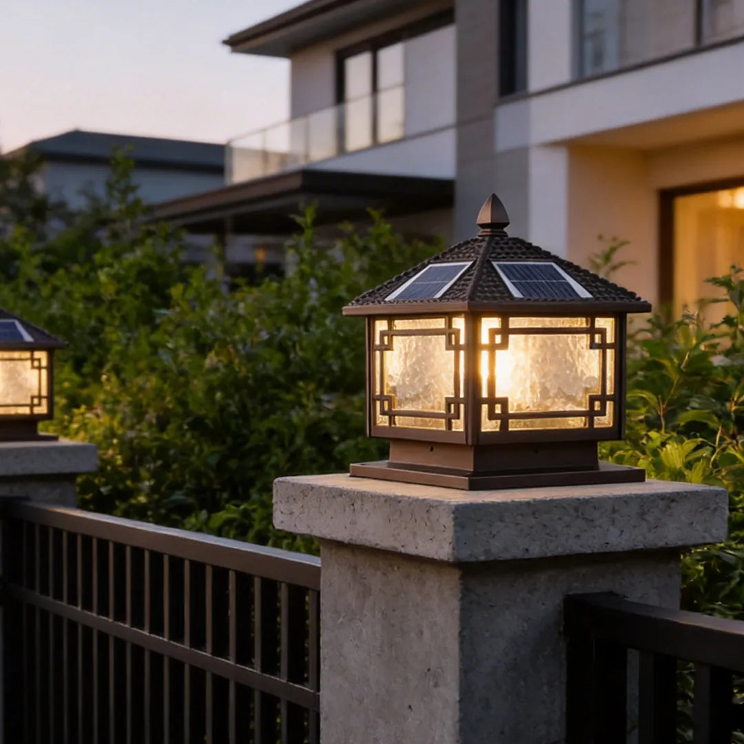 Outdoor garden pillar lights placed on fence columns, providing warm accent lighting for a modern outdoor space.